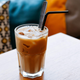 Glass of Vietnamese iced coffee with a straw